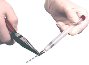 Remove the needle from the syringe using pliers.
