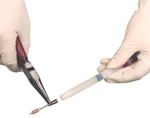 Mount the hypodermic needle onto the dart syringe boss using pliers